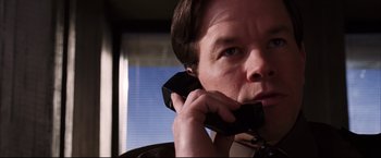Movie still from “The Departed” (2006), directed by Martin Scorsese – A person talking on a cell phone; Close Up shot, Low angle