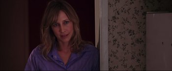 Movie still from “The Departed” (2006), directed by Martin Scorsese – A woman standing in front of a door; Close Up shot, Over the shoulder angle