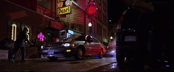 Movie still from “The Departed” (2006), directed by Martin Scorsese – A car driving down a street at night; Wide shot, Low angle