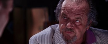 Movie still from “The Departed” (2006), directed by Martin Scorsese – An older man with a beard and a striped shirt; Close Up shot, Low angle