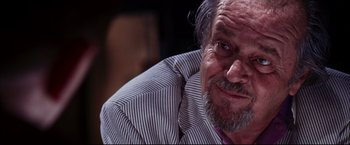 Movie still from “The Departed” (2006), directed by Martin Scorsese – An old man with a beard and a striped shirt; Close Up shot, Low angle