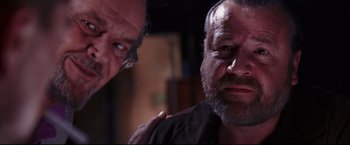 Movie still from “The Departed” (2006), directed by Martin Scorsese – A man with a goatee is looking at the camera with another man; Close Up shot, Low angle