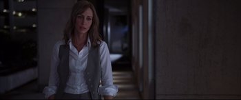 Movie still from “The Departed” (2006), directed by Martin Scorsese – A woman in a white shirt and a gray vest; Medium shot, Over the shoulder angle