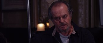Movie still from “The Departed” (2006), directed by Martin Scorsese – An older man with a beard and mustache looking at the camera; Close Up shot, Low angle