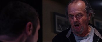 Movie still from “The Departed” (2006), directed by Martin Scorsese – A man in a black shirt is looking at another man in a black shirt; Close Up shot, Over the shoulder angle