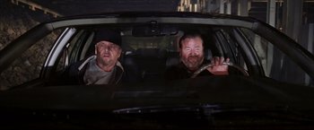 Movie still from “The Departed” (2006), directed by Martin Scorsese – A couple of men sitting in the back of a car; Medium shot, Over the shoulder angle