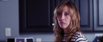 Movie still from “The Departed” (2006), directed by Martin Scorsese – A person with long blonde hair; Close Up shot, Over the shoulder angle