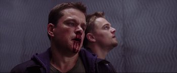 Movie still from “The Departed” (2006), directed by Martin Scorsese – Two men with blood on their faces and one is bleeding; Close Up shot, Low angle