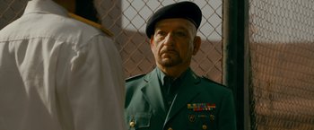 Movie still from “The Dictator” (2012), directed by Larry Charles – An older man in a military uniform looking at a man in a uniform; Close Up shot, Over the shoulder angle
