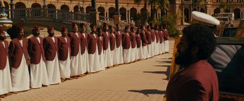 Movie still from “The Dictator” (2012), directed by Larry Charles – A group of men in long robes standing in a line; Extreme Wide shot, High angle