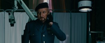 Movie still from “The Dictator” (2012), directed by Larry Charles – A man in a uniform talking on a cell phone; Close Up shot, Low angle