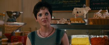 Movie still from “The Dictator” (2012), directed by Larry Charles – A woman standing in front of a display of pastries; Close Up shot, Over the shoulder angle