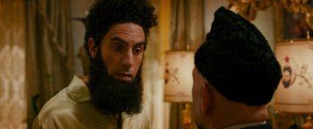 Movie still from “The Dictator” (2012), directed by Larry Charles – A man with a long beard looking into a mirror; Close Up shot, Over the shoulder angle
