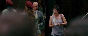 Movie still from “The Dictator” (2012), directed by Larry Charles – A group of people standing next to each other on a sidewalk; Medium shot, Over the shoulder angle