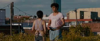 Movie still from “The Dictator” (2012), directed by Larry Charles – A man and a woman standing on top of a building; Medium shot, Over the shoulder angle