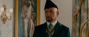 Movie still from “The Dictator” (2012), directed by Larry Charles – A man in a military uniform wearing medals; Close Up shot, Over the shoulder angle