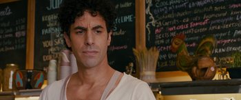 Movie still from “The Dictator” (2012), directed by Larry Charles – A person in a room; Close Up shot, Over the shoulder angle