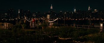Movie still from “The Dictator” (2012), directed by Larry Charles – A man standing on top of a lush green field; Extreme Wide shot, High angle