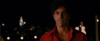 Movie still from “The Dictator” (2012), directed by Larry Charles – A person wearing a red shirt; Close Up shot, Over the shoulder angle