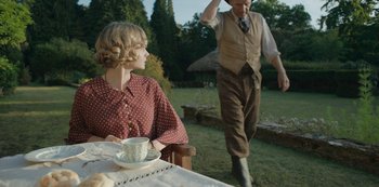 Movie still from “The Dig” (2021), directed by Simon Stone – An older man and a young woman are outside; Medium shot, Over the shoulder angle