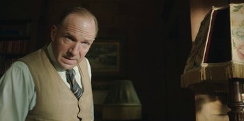 Movie still from “The Dig” (2021), directed by Simon Stone – A man in a tie and vest looking at the camera; Close Up shot, Low angle