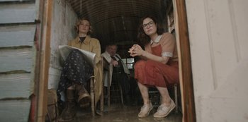 Movie still from “The Dig” (2021), directed by Simon Stone – Two women and a man sitting in a room; Medium shot, Low angle
