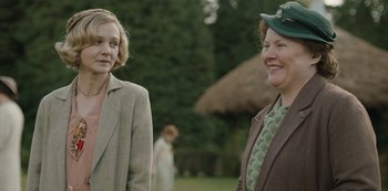 Movie still from “The Dig” (2021), directed by Simon Stone – Two women standing next to each other in a field; Medium shot, Over the shoulder angle