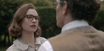 Movie still from “The Dig” (2021), directed by Simon Stone – A man and a woman wearing glasses talking to each other; Close Up shot, Over the shoulder angle