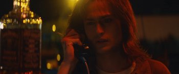 Movie still from “The Dirt” (2019), directed by Jeff Tremaine – A woman talking on a phone in the dark; Close Up shot, Low angle