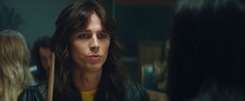 Movie still from “The Dirt” (2019), directed by Jeff Tremaine – A man with long hair wearing a leather jacket; Close Up shot, Over the shoulder angle