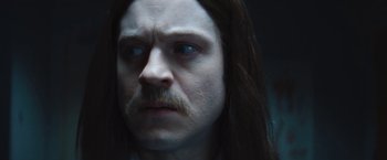 Movie still from “The Dirt” (2019), directed by Jeff Tremaine – A person with long hair and a mustache; Close Up shot, Over the shoulder angle