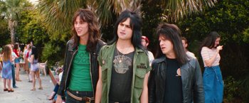 Movie still from “The Dirt” (2019), directed by Jeff Tremaine – A group of young men standing next to each other on a street; Medium shot, Low angle