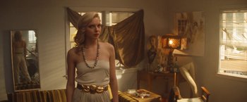 Movie still from “The Dirt” (2019), directed by Jeff Tremaine – A beautiful blonde woman wearing a white dress; Medium shot, Over the shoulder angle