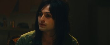 Movie still from “The Dirt” (2019), directed by Jeff Tremaine – A person with long black hair; Close Up shot, Low angle