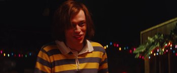 Movie still from “The Dirt” (2019), directed by Jeff Tremaine – A young man in a yellow and blue striped shirt; Medium shot, Low angle