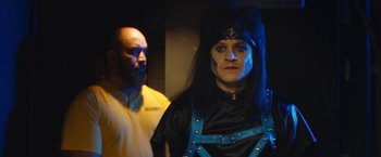 Movie still from “The Dirt” (2019), directed by Jeff Tremaine – A man and a woman dressed up in costumes; Close Up shot, Over the shoulder angle