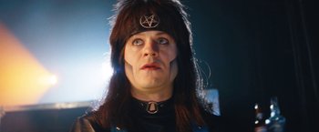 Movie still from “The Dirt” (2019), directed by Jeff Tremaine – A person with a black hat and a black shirt; Close Up shot, Low angle