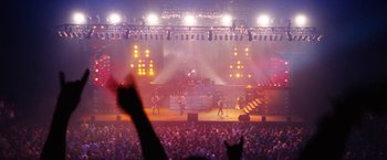 Movie still from “The Dirt” (2019), directed by Jeff Tremaine – A crowd of people watching a band perform on stage; Extreme Wide shot, High angle