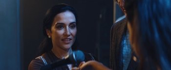 Movie still from “The Dirt” (2019), directed by Jeff Tremaine – A woman is smiling while being interviewed by a man; Close Up shot, Over the shoulder angle