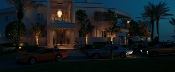 Movie still from “The Dirt” (2019), directed by Jeff Tremaine – A man standing on the side of the road next to a car; Extreme Wide shot, High angle