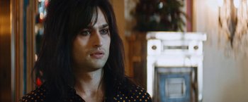 Movie still from “The Dirt” (2019), directed by Jeff Tremaine – A person with long black hair; Close Up shot, Over the shoulder angle