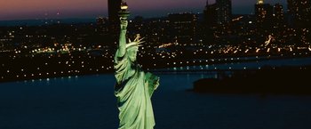 Movie still from “The Dirt” (2019), directed by Jeff Tremaine – The statue of liberty is lit up at night; Extreme Wide shot, Low angle