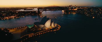 Movie still from “The Dirt” (2019), directed by Jeff Tremaine – An aerial view of the sydney opera house at night; Extreme Wide shot, High angle