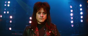 Movie still from “The Dirt” (2019), directed by Jeff Tremaine – A man with long black hair wearing a leather jacket; Close Up shot, Low angle