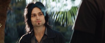 Movie still from “The Dirt” (2019), directed by Jeff Tremaine – A person with long black hair; Close Up shot, Low angle