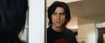 Movie still from “The Dirt” (2019), directed by Jeff Tremaine – A person with long black hair; Close Up shot, Over the shoulder angle