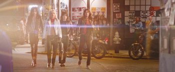 Movie still from “The Dirt” (2019), directed by Jeff Tremaine – A group of people walking down a street at night; Wide shot, Low angle