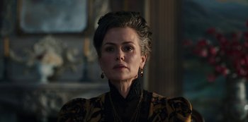 Movie still from “The Empress” (2022), created by Katharina Eyssen – An older woman wearing a black and gold dress; Close Up shot, Low angle