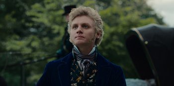 Movie still from “The Empress” (2022), created by Katharina Eyssen – A man in a suit and tie looking to his left; Close Up shot, Low angle