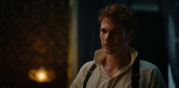 Movie still from “The Empress” (2022), created by Katharina Eyssen – A man with a beard is wearing a white shirt and black suspenders; Close Up shot, Over the shoulder angle